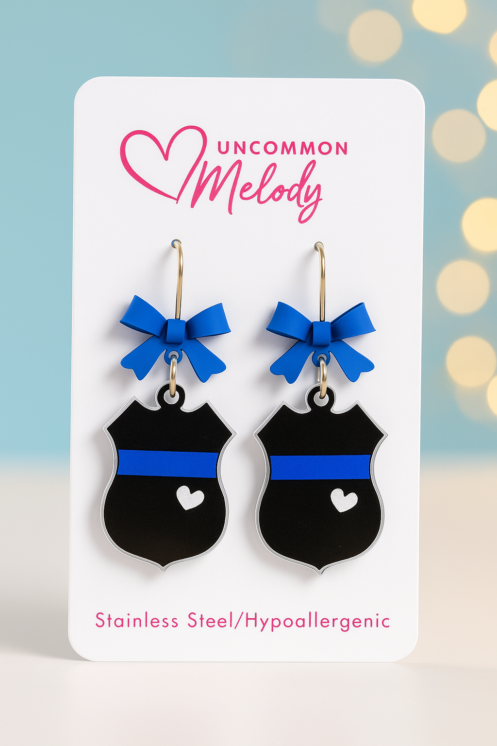 Product Title:
Blue Line Police Badge Earrings with Bow – UV Printed Acrylic | Uncommon Melody